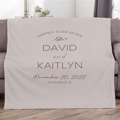 a personalized wedding blanket is shown on a couch in front of a window with the words happily ever after, david and kathy