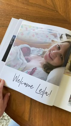 a person holding up a book with an image of a baby on it and the words welcome lepla