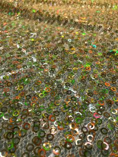 an image of many different colored bubbles on the ground with water droplets all over it