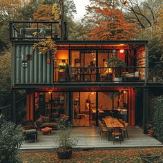 a house made out of shipping containers in the woods