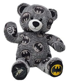 a batman teddy bear sitting up against a white background