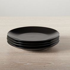 four black plates stacked on top of each other