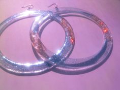 Extra Large Hoop Earrings, Huge Sparkly Party Hoops, 4 Inch Laser Cut Clear Acrylic Festival Hoops, Funky Extravagant Disco Glitter Hoops --Materials: laser cut plexiglass bases, glitter high quality resin, Hooks ~> you can choose material Brass OR Sterling Silver --Dimension: 10 cm (4 in) x 12 cm length (4.7 in) These lovelies are so lightweight--> you are going to forget you are wearing them! Firstly, i come up with the design, making some quick sketches, I then design them in my laptop Glitter Party Jewelry, Silver Sparkling Hoop Earrings For Parties, Sparkling Silver Hoop Earrings For Party, Silver Hoop Earrings For Party, Party Hoop Earrings With Bling, Silver Shiny Jewelry For Party, Shiny Silver Jewelry For Party, Glamorous Silver Hoop Earrings For Party, Glamorous Party Jewelry With Glitter