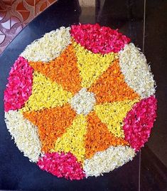 a black table topped with flowers and an umbrella shaped decoration on it's side