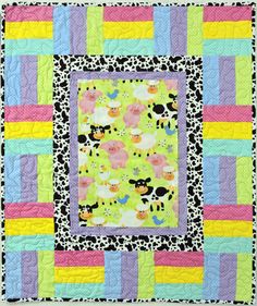 a colorful quilt with squares and flowers on it