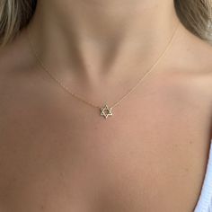 Make a meaningful statement with this 14K gold mini Star of David necklace. An elegant symbol of faith, it is the perfect accessory to express your beliefs. Its slim design makes it easy to layer and mix with other necklaces for added visual appeal. Chain sold separately. Item Information Metal: 14k Gold Weight: 0.9g Dimensions: 9.5x8.35mm Length: 16"-18" Dainty Star Of David Necklace, Dainty Star Of David Jewelry With Adjustable Chain, Dainty Star Of David Charm Necklace With Delicate Chain, Dainty Star Of David Necklace With Star Charm, Yellow Gold Star Of David Jewelry With Delicate Chain, Yellow Gold Star Of David Necklace With Delicate Chain, Delicate 14k Gold Star Necklace, Gold Minimalist Star Of David Charm Necklace, Minimalist Gold Necklace With Star Of David