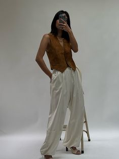 The Cooper Cargo Pant in our perennial favorite fabric, silk canvas, features a structured yet warm silk hand quintessentially perfect across all seasons. The Cooper features a comfortable yet elegant elastic + drawstring waistline, easy side and utilitarian pockets, and adjustable ties at the bottom to allow for a balloon silhouette or wide leg fit. We truly love this updated classic for its ease of styling and functionality - the Cooper Cargos share endless possibilities from day to evening af Satin Parachute Pants, Silk Cargo Pants Outfit, Silk Pants Outfit Street Styles, Silk Pants Outfit, Silk Cargo Pants, Balloon Silhouette, Minimalist Outfits, House Items, Cargo Pants Outfit