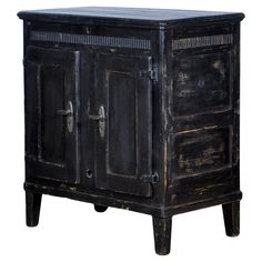 an old black wooden cabinet with two doors