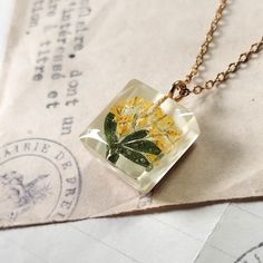 Real pressed flowers, Botanical gift for women, Unique minimalist jewelry, Small pendant for girl, Gift for daughter's birthday. An unusual handicraft as a birthday gift, perfect for a lover of nature and unique jewelry. For women who want to wear unique jewelry in the whole world. Made by me from start to finish with attention to every detail. I put a lot of work, patience and heart into each single piece of jewelry. Personally, I collect and dry plants, which I later use to create.  Pendant si Dainty Handmade Rectangular Jewelry, Delicate Green Jewelry For Gifts, Handmade Dainty Rectangular Jewelry, Botanical Jewelry With Pressed Flowers, Yellow Resin Jewelry As Gift, Minimalist Flower Jewelry With Pressed Flowers, Dainty Rectangular Jewelry Gift, Dainty Rectangular Jewelry For Gifts, Yellow Resin Jewelry As A Gift