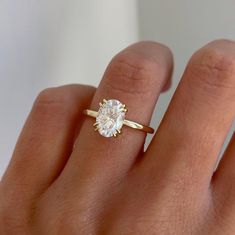 a woman's hand with a diamond ring on it