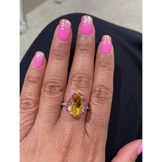 This gorgeous ring has a magnificent Pear Cut Citrine Quartz weighing 5.28 Carats and is surrounded by 25 Pink and Yellow Sapphires that weigh 0.60 carats and 20 Round Cut Diamonds that weigh 0.37 carats. (Clarity: SI, Color: F) The total carat weight of the ring is 6.25 carats. Each stone is handpicked and carefully curated to create a unique piece by our in-house designer and jeweler! The Citrine measures approximately at 11 mm x 16 mm. It is set in 14K White Gold and weighs approximately 3.8 Luxury Multi-stone Yellow Gemstones, Luxury Yellow Multi-stone Gemstones, Luxury Yellow Pear-shaped Ring, Luxury Multi-stone Yellow Diamond Ring, Formal Yellow Multi-stone Diamond Ring, Luxury Yellow Gemstones With Accent Stones, Luxury Yellow Sapphire Multi-stone Ring, Elegant Yellow Sapphire Multi-stone Jewelry, Yellow Multi-stone Sapphire Ring