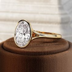 a close up of a gold ring with a white diamond on the top and bottom