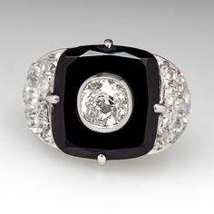 This awesome circa 1920s Art Deco dinner ring is centered with a rectangular onyx tablet in a four-prong setting. The center of the onyx is bezel set with one (1) old mine cut diamond, weighing 0.87 carats. The shoulders are each bead set with ten (10) antique cut diamonds. The ring measures 15.6mm at the top, rises 9.9mm above the finger, tapering to 1.7mm wide and 1.0mm thick at the base of the shank.  It is currently a size 7.75. Formal Art Deco Rings With Black Enamel, Art Deco Black Enamel Rings For Formal Occasions, Classic Onyx Diamond Ring, Vintage Black Diamond Ring With Diamond Accents, Timeless Rectangular Jewelry With Rose Cut Diamonds, Elegant Black Rectangular Signet Ring, Elegant Signet Ring With Rectangular Gemstone, Black Art Deco Signet Ring For Anniversary, Vintage Black Enamel Rectangular Jewelry