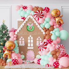 a gingerbread house is surrounded by balloons and other decorations for a christmas themed party