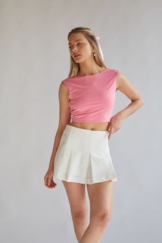 Maggie Tie Back Crop Top is the perfect elevated basic! This cute top features a sleeveless bodice, high neckline, cropped fit, and an open back with an adjustable tie. Available in white and pink. Pair with a cute mini skirt to complete the look! Details 95% Polyester, 5% Spandex Double lined Hand wash cold / Line dry Pink Top White Skirt, Tie Back Crop Top, Open Back Crop Top, Cute Mini Skirt, American Threads, White Skirt, Ruffled Maxi Dress, Lace Ruffle, Sweater Sale