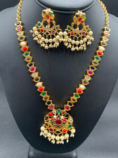 Navarathna Stones with Pearls necklace set Handmade jewelry One gram gold jewelry Silver plated jewelry Official Website globusfashions.com 🌸 S H O P . M O R E . S T Y L E S 🌸 https://www.etsy.com/shop/Globusfashions Necklaces - https://www.etsy.com/shop/Globusfashions?section_id=18712263 Bracelets - https://www.etsy.com/shop/Globusfashions?section_id=18969767 Pendant Sets - https://www.etsy.com/shop/Globusfashions?section_id=18707402 Tikka - https://www.etsy.com/shop/Globusfashions?section_id Multicolor Gold Plated Kundan Necklace With Meenakari, Multicolor Meenakari Gold-plated Necklaces, Multicolor Meenakari Kundan Necklace Gold Plated, Multicolor Meenakari Gold Plated Necklaces, Multicolor Meenakari Gold-plated Necklace, Multicolor Temple Necklace With 17 Jewels For Wedding, Multicolor Hand Set Temple Jewelry Sets, Multicolor Temple Necklace With 17 Jewels, Multicolor 17 Jewels Temple Necklace