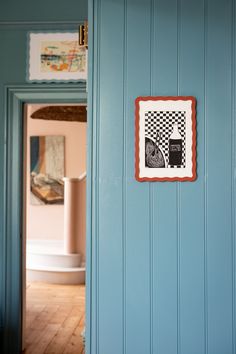 a room with blue walls and pictures on the wall