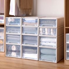 an organized closet with clear bins filled with clothes