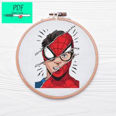 a cross stitch spider - man with glasses on it's face is shown in the hoop