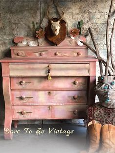 an old dresser with antlers on it and the words dare to be vintage