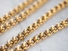 Dating to the late 1800s or early 1900s, this Victorian chain is detailed with formed, beaded ribbon themed links. The craftsmanship is superb, each link forming a tiny work of art. The style is very gothic and would be suitable for a man or a woman, perfect alone or worn with a pendant. Metal: 14K Yellow Gold Width of Chain: 4.8 mm, width Length of Chain: 20 Inch Chain Weight: 10 Grams Beaded Ribbon, Gold Link Chain, Cameo Ring, July Birthstone, Yellow Gold Chain, Gold Chain Necklace, Early 1900s, Eternity Bands, Chain Styles