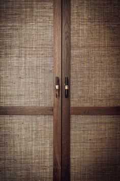 a close up of a wooden door with two handles