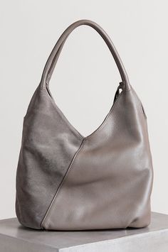 click to expand Taupe Textured Leather Shoulder Bag, Modern Rectangular Suede Hobo Bag, Taupe Leather Bag With Leather Handles, Leather Hobo Bag In Taupe For Everyday Use, Taupe Leather Hobo Bag For Everyday Use, Versatile Leather Hobo Bag With Leather Handles, Leather Taupe Hobo Bag For Everyday Use, Modern Leather Hobo Shoulder Bag, Modern Leather Hobo Bag For Daily Use