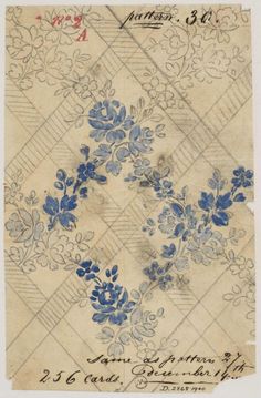 an old piece of paper with blue flowers and leaves on the bottom half of it