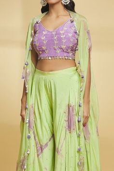 Purple and green cape with gota embroidery. Paired with an embroidered blouse and flared palazzo. - Aza Fashions Bollywood Style Green Choli For Spring, Traditional Green Choli For Spring, Traditional Green Lehenga For Spring, Green Sets With Dupatta For Spring, Fitted Green Sharara For Spring, Festive Green Choli For Spring, Spring Festive Green Choli, Spring Green Sets With Gota Work, Spring Bollywood Choli With Dupatta