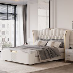 a bedroom with a large bed and white furniture