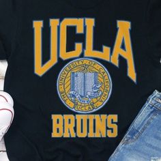 Vintage Ncaa Ucla Bruins Logo Shirt, Vintage Graphic Tee, University Of California Shirt, Unisex T-Shirt Sweatshirt, Gift For Fan Black Sporty Tops With University Logo, Black College Tops With University Logo, Collegiate Black T-shirt With Letter Print, Graphic Print T-shirt For College Game Day, College Style Crew Neck T-shirt With Team Name, Black School Spirit Graphic Tops, College Style T-shirt For Game Day With Letter Print, College Style Graphic T-shirt For Game Day, Black T-shirt With Letter Print For College