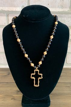 This piece features a striking combination of rich red beads and shimmering gold-tone beads. At the center hangs a gold-tone cross pendants with a unique textured finish. Perfect for both casual wear and special occasions, this necklace is versatile enough to complement a variety of outfits, making it a must-have piece. Handmade Adjustable Black Cross Necklace, Handmade Black Cross Necklace, Black Bohemian Cross Necklace, Beaded Cross Necklace, Handmade Black Crucifix Necklace, Black Beaded Cross-shaped Rosary, Red Beads, Beaded Cross, Of Outfits