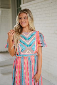 Elevate your wardrobe with our stunning Embroidered Fringe Midi Dress in multi colors. Boasting a crew neckline, puff sleeves, and intricate Aztec embroidery, this dress offers a flattering v back, side cut outs, and an elastic waistline for the perfect fit. The scalloped bottom hem and fringe detailing add a playful touch. 100% cotton Partially lined Model is 5'6" with a 34" bust, 27" waist, and 36" hips wearing a size small Size rec: S 0-4 M 4-6 L 8-10 Embroidered Multicolor V-neck Dress, Multicolor V-neck Embroidered Maxi Dress, Multicolor V-neck Dress With Tassels, Fringe Midi Dress, Aztec Embroidery, Summer V-neck Dress With Fringe, Casual V-neck Fringe Dresses, Loungewear Summer, Side Cuts