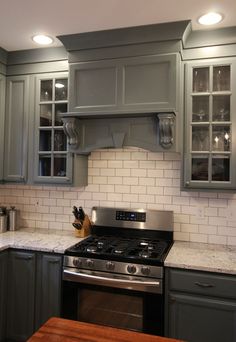 a stove top oven sitting inside of a kitchen