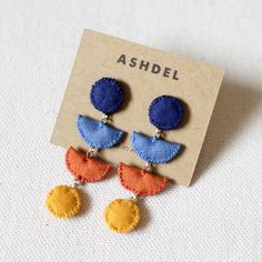 the earrings are made from fabric and have two different colors on each earring, one with