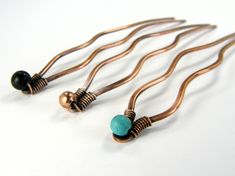 "Beaded copper hair forks. In Turquoise, copper or black. These hammered copper wire hair pins will keep your hair in place all day long. They are great for holding and making buns. This minimalist hair stick design is handmade in the USA from sturdy 12-Gauge copper wire. These are antiqued for a rustic Boho look. Each one is carefully handmade with Love. Copper jewelry is always a nice sentimental 7th anniversary gift. They are 4-1/2\" long by 3/4\" Wide. Lengths are from end to end. Beads may Hair Up In A Bun, Hair Forks, Bun Pins, Minimalist Hair, Beaded Hair, Beautiful Hair Accessories, Hair Fork, Copper Hair, Hair Stick