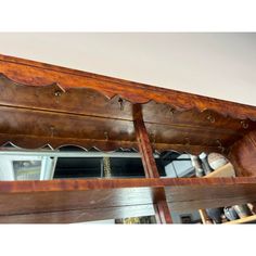 an old wooden shelf with some drawers underneath it