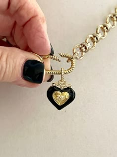 This shiny gold-plated cable chain necklace has a great weight to it. It connects to a gold rope design spring lock carabiner. The pendant is made of black enamel, pave stones, and a double heart in gold. The bale on the pendant is also encrusted in pave. This is a show-stopping necklace of modern and trendy design. The chain is lead-safe and nickel free. The chain's large link is 1/2 in and the middle link is 1/4 in. The Carabiner and chain is brass with 14k gold plating. The length of the neck Gold Charms For Necklace, Carabiner Necklace, Kids Picnic, Necklace Packaging, Necklace Charms, Womens Chokers, Cable Chain Necklace, Necklace Clasps, Heart Pendant Gold