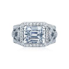 an emerald cut diamond ring with diamonds around it