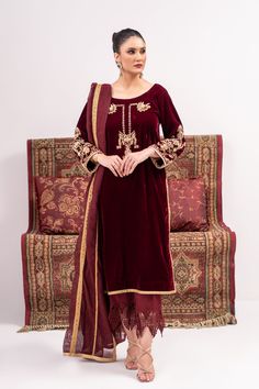 A deep red velvet suit with traditionally inspired full hand embroidery and emphasized with kora and nakshi work. Paired with a khadi silk dupatta with gota work lines on it and a velvet pajama with silk work on the bottom.3-piece suitReady-to-wear Festive Velvet Saree Set, Traditional Velvet Salwar Kameez With Straight Kurta, Red Raw Silk Traditional Wear With Naqshi, Red Sharara With Naqshi In Traditional Drape, Red Unstitched Sharara With Naqshi Detailing, Red Naqshi Sharara With Traditional Drape, Traditional Velvet Kurta With Zari Work, Traditional Semi-stitched Velvet Kurta, Velvet Straight Kurta With Zari Work