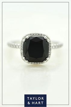 a black and white diamond ring with the words taylor & hart on it's side