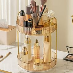 a gold makeup organizer on a marble countertop