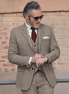 For your most important event, you demand excellent attire to make the occasion far more supreme. Crafted with wool, our Houndstooth Brown Tweed Suit is designed with a houndstooth pattern that looks like small broken squares and brown color will capture your perfect depiction to the world and it also gives comfort at every wear. So grab this very elegant suit that will make you look lavish on your day.  Look Includes   Houndstooth Brown Tweed Fabric  Two Button Jacket Style  Notch Lapel  Horn Brown Buttons  Single Vent  Three Cuff Buttons  Two Welted Back Pockets on Trousers    Click 'Customize Now' to modify the look if needed.   Lining: Viscose; Dry Clean. Elegant Tweed Jacket With Houndstooth Pattern, Elegant Houndstooth Tweed Jacket For Tailoring, Classic Houndstooth Suits For Winter, Formal Brown Herringbone Suits, Tweed Jacket With Houndstooth Pattern For Business Casual, Formal Brown Herringbone Pattern Suit, Brown Herringbone Pattern Suit For Formal Occasions, Elegant Tweed Jacket With Houndstooth Pattern And Suit Collar, Tailored Houndstooth Tweed Jacket For Business