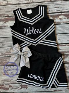 a cheerleader outfit with a bow on the side and words that say wolverines