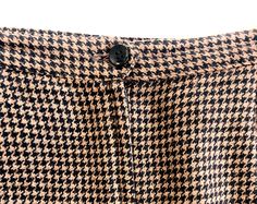 "Brown houndstooth pattern pencil skirt | Zipper with button closure in back | Split back with side pockets | Fully lined LABEL- (No size tag - appears to be size medium) 40% polyester 30% Acrylic 20% Wool 4% Nylon 4%Viscose Rayon 2% Cotton MEASURMENTS- (Laid flat) Waist: 30\" Hip: 40\" Length: 20.5\" (Model's measurements - Bust 36\", Waist 27.5\", Hip 34\", 5' 3\" Tall) Good vintage condition with minor wear (See photos for details) Follow me on Instagram @MissSarahBelleVintage" Houndstooth Pencil Skirt For Work, Houndstooth Mini Skirt For Workwear, Houndstooth Pattern Mini Skirt For Workwear, Chic Houndstooth Pencil Skirt, Pattern Pencil Skirt, Vintage Goblets, Houndstooth Pencil Skirt, Skirt Zipper, Corduroy Dress