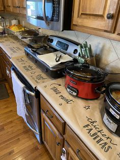 the kitchen counter has many pots and pans on it