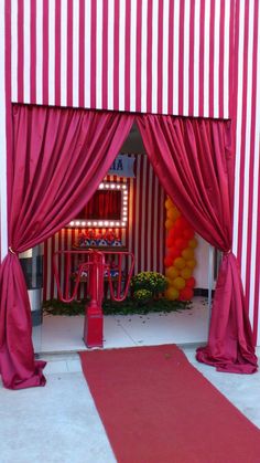 a red and white striped tent with curtains