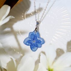 *This is a custom initial handmade necklaces with a blue hydrangea dried flower design. We have sealed the beautiful flowers in resin and paired them with a silver or gold Components, Let the colors of nature whisper around you. *Optional chain length: 14in / 16in / 18in / 20in You can leave me a message the length of the chain you need. Default chain length: 18 inches If there is no message, it is regarded as the default length. *Free Message Card: We offer a complimentary message card service Cheap Handmade Blue Flower Necklace, Pressed Hydrangea, Hydrangea Dried, Resin Necklaces, Blue Hydrangea Flowers, Flower Necklaces, Necklaces Handmade, Flower Resin, Flower Pendant Necklace