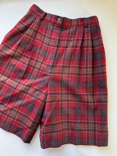 "Vintage 1970s Pendleton plaid high rise wool trouser shorts.  Great vintage condition. No notable flaws.  Marked size women's 4. See measurements below to ensure fit.  Keep in mind these are high rise and sit at narrowest part of the waist and are measured flat and how they lay naturally. Waist across laid flat: 11.75\" Hips across laid flat, below zipper: 20\" Inseam: 8.5\" Front rise: 12.5\" Thigh laid flat: 12.75\" Leg opening across laid flat: 11.5\"" Plaid Short Bottoms For Fall, Fall Plaid Shorts, Vintage Knee-length Winter Bottoms, Vintage Knee-length Bottoms For Winter, Retro Short Bottoms For Fall, Vintage High Waist Plaid Bottoms, Retro Wool Bottoms For Fall, Plaid Knee-length Bottoms For Fall, Knee-length Plaid Bottoms For Fall