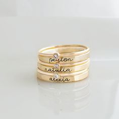 The Brynn Ring Set These personalized rings for mom include three name rings with stackable birthstone rings with meaning. This a gorgeous ring aesthetic and a best seller! This set includes three 2mm name rings in our lowercase cursive font (silver or 14K yellow gold-filled), and three birthstone rings. Please swipe through all photos for details of gold-filled metals. 14k Gold Stackable Rings With Custom Name For Anniversary, Custom Name Stackable Rings In 14k Gold For Anniversary, Custom Name 14k Gold Stackable Rings For Anniversary, Personalized Sterling Silver Yellow Gold Birthstone Ring, Personalized Adjustable 14k Gold Stackable Rings, Everyday Stackable Rings With Custom Name, Mother's Day 14k Gold Stackable Rings, Personalized Adjustable Stackable 14k Gold Rings, Custom Name Adjustable Stackable Wedding Rings